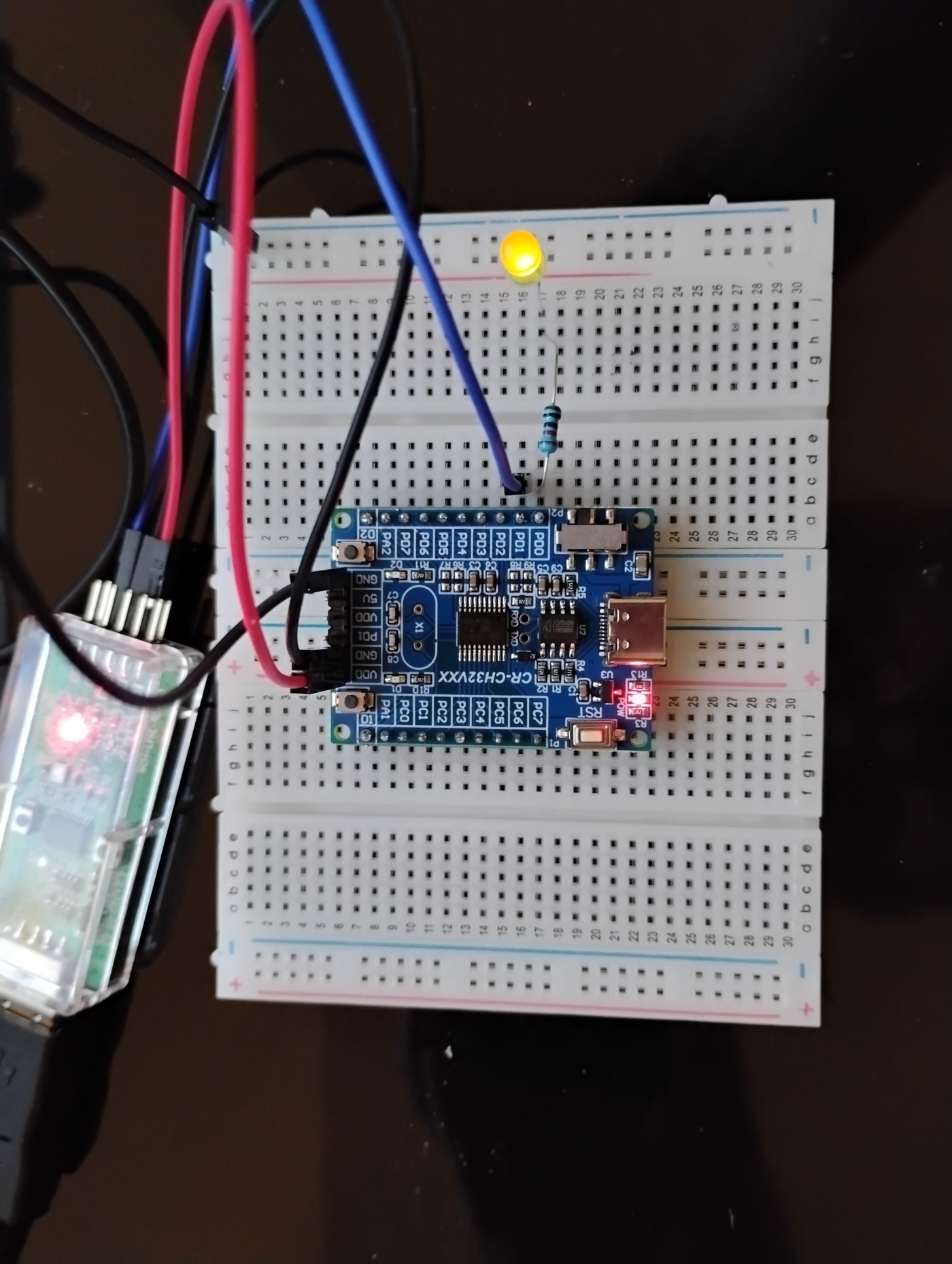CH32V003 board on a breadboard with an LED lit at a changed blink rate